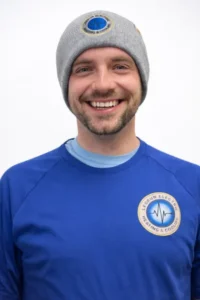 Meet Our Family! A man wearing a gray beanie and a blue "Everrun Electric Heating & Cooling" shirt smiles at the camera against a plain white background.